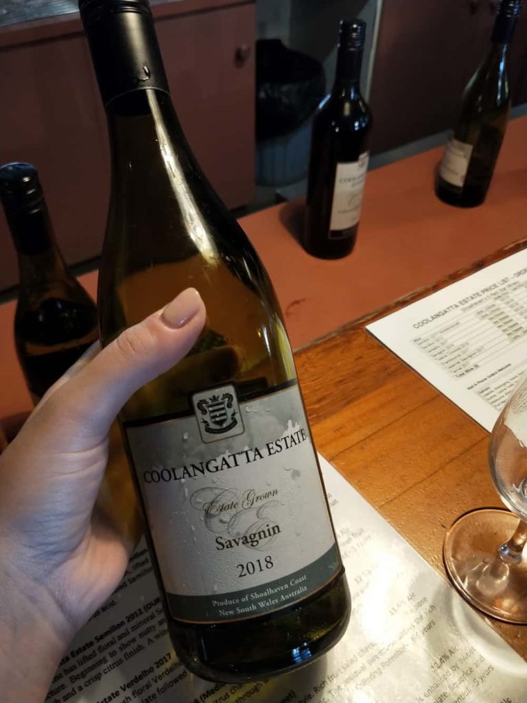 hand holding savagnin white wine bottle from Shoalhaven Coast winery