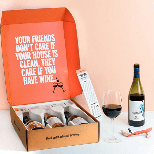 good pair days wine delivery service box with three wines, white quote on orange background and glass of wine